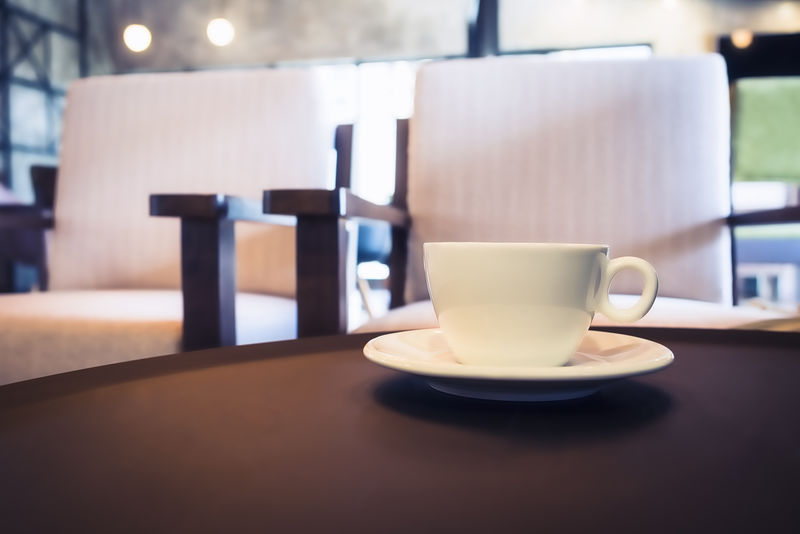 咖啡桌上的咖啡杯和咖啡馆的座位