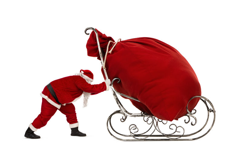 圣诞老人推着雪橇大袋子里装着白色背景的圣诞礼物