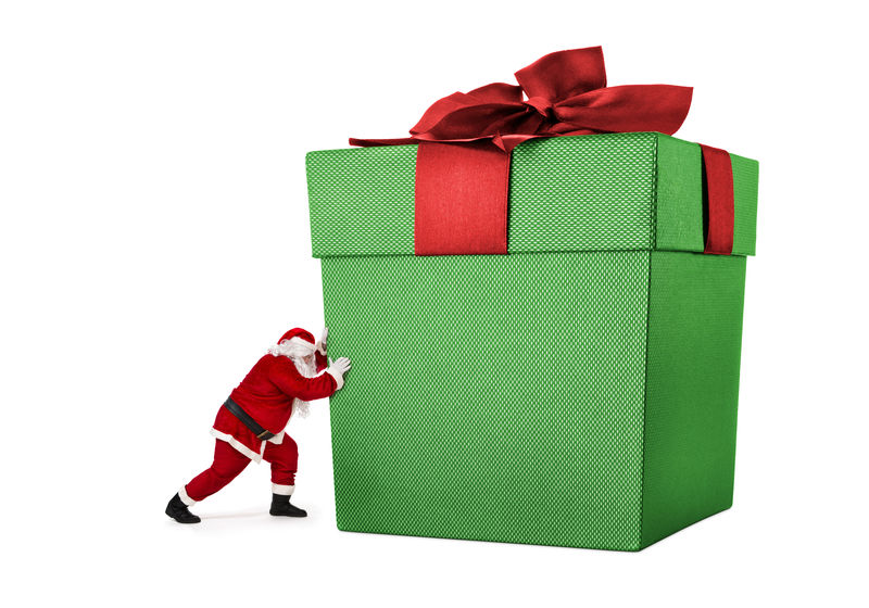 圣诞老人推着一个大礼盒里面装满了白色背景的礼物