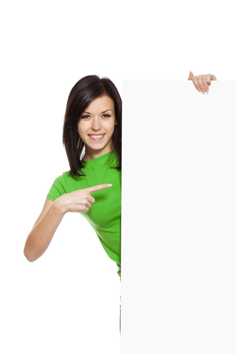 年轻快乐的微笑女人站着-手指着一块白板-漂亮的女孩穿着绿色衬衫-白底独立-摄影棚拍摄