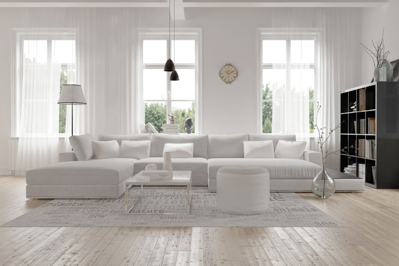 现代宽敞的休息室或起居室内部-配有单色白色家具-三扇高而明亮的窗户下有装饰-角落里有深色书柜-三维渲染
