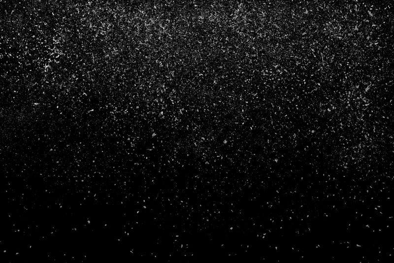 白色粉末落下时的冻结运动-孤立在黑色、深色背景上-降尘云的抽象设计-粒子云屏保-壁纸与复制空间-雨雪落概念