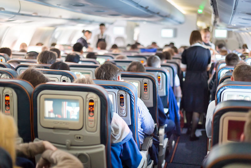 乘客坐在座位上的飞机内部。