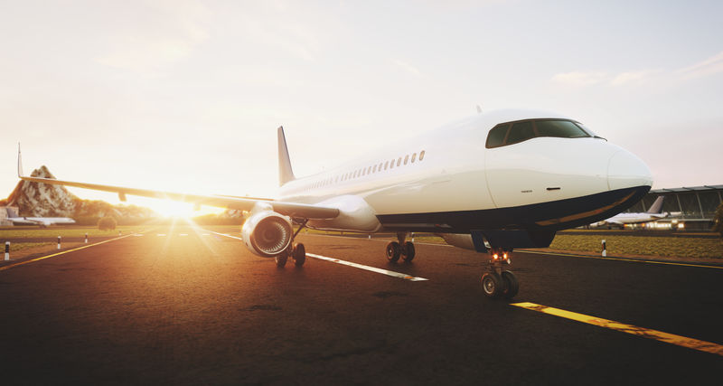 日落时分，白色的商用飞机停在机场跑道上。客机正起飞。飞机概念三维图。