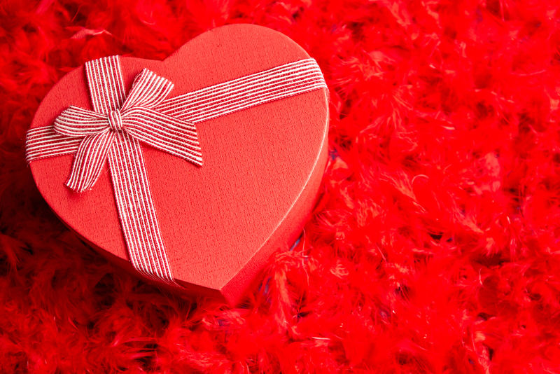 心形盒装礼物，红色羽毛背景