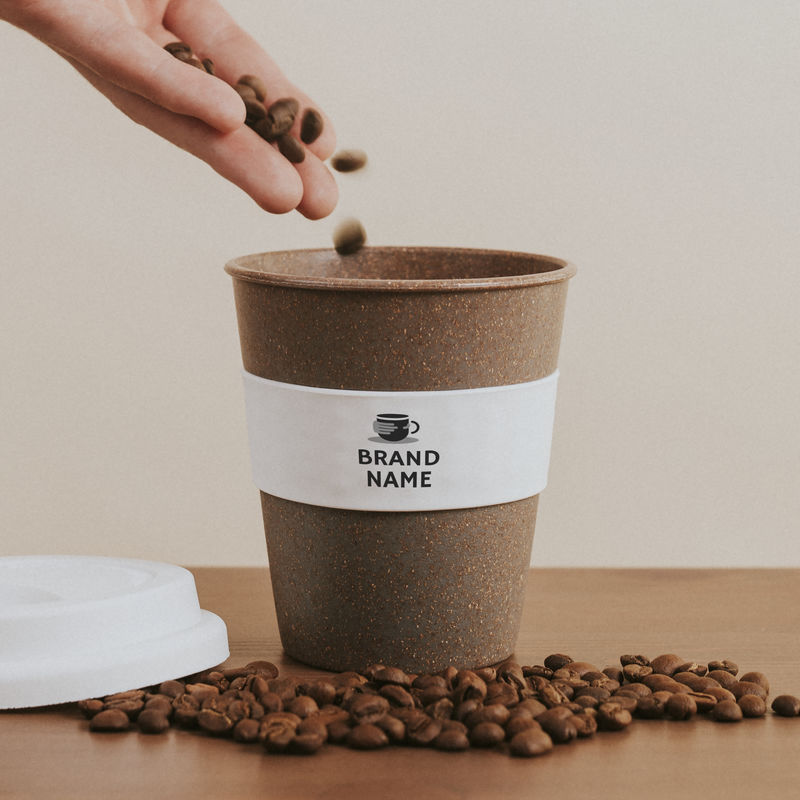 用手将咖啡豆倒入软木咖啡杯模型中
