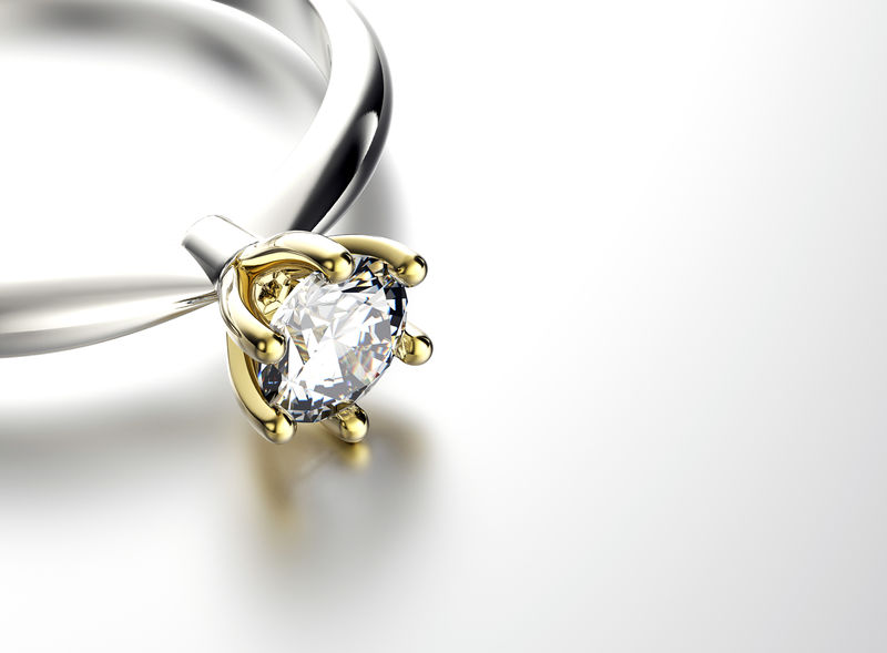 镶有钻石或莫桑石的订婚戒指珠宝背景