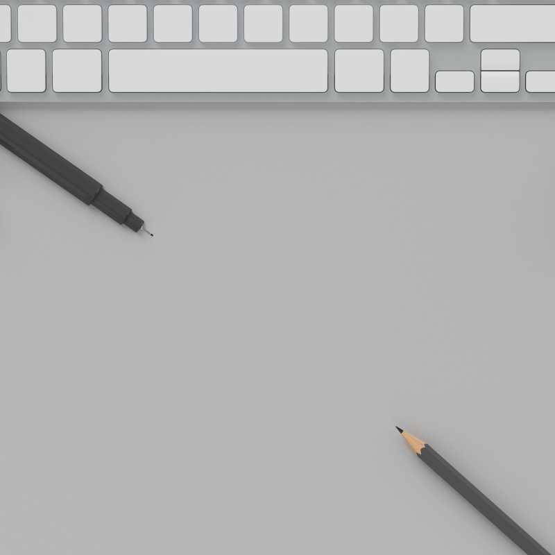 黑色铅笔和电脑上的浅灰色粉彩背景复制空间