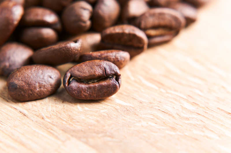 木桌上聚焦前景的咖啡豆