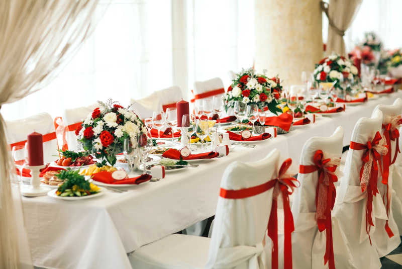 结婚婚礼餐桌上的红色玫瑰花和餐盘装饰