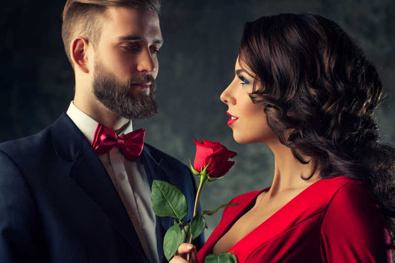 红衣女人拿着玫瑰看着男人