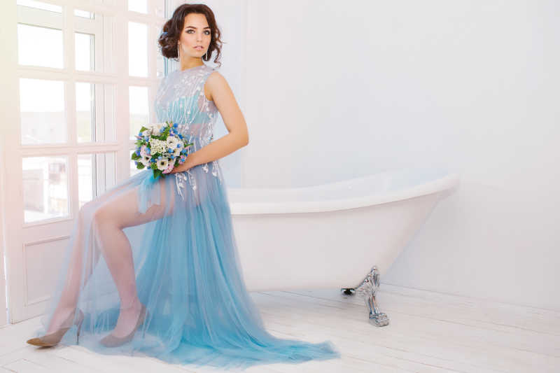 坐在浴缸上的蓝色纱裙新娘