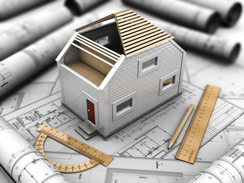 设计图纸笔尺子和3d房屋模型