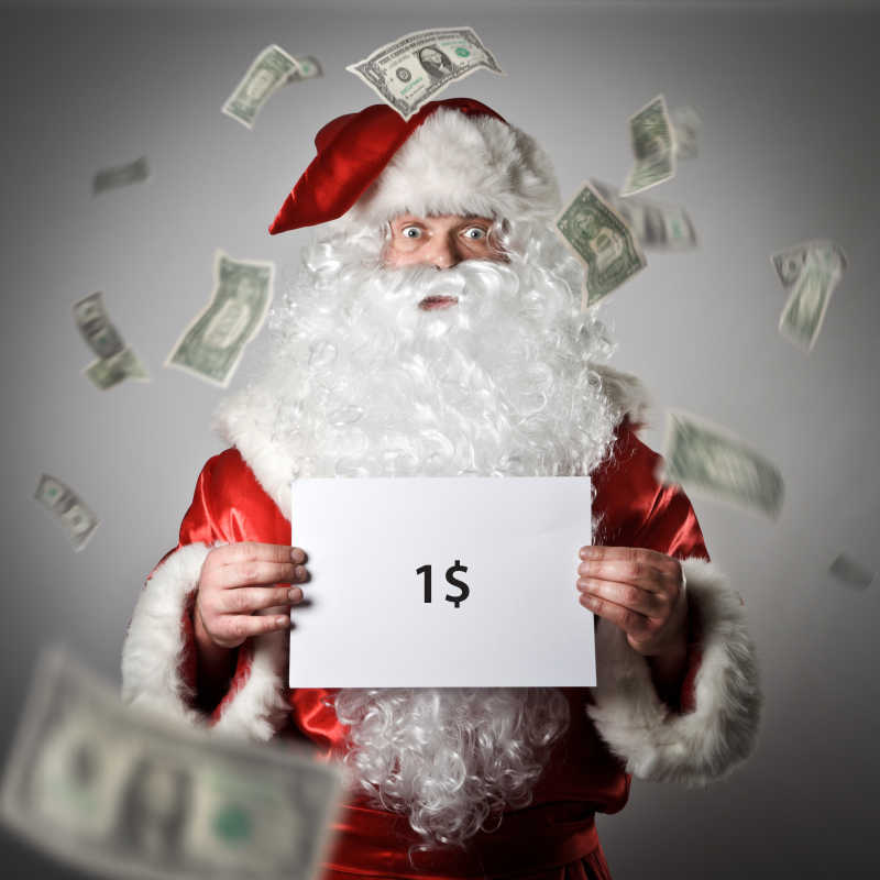 圣诞老人手拿写着1元钱的白纸